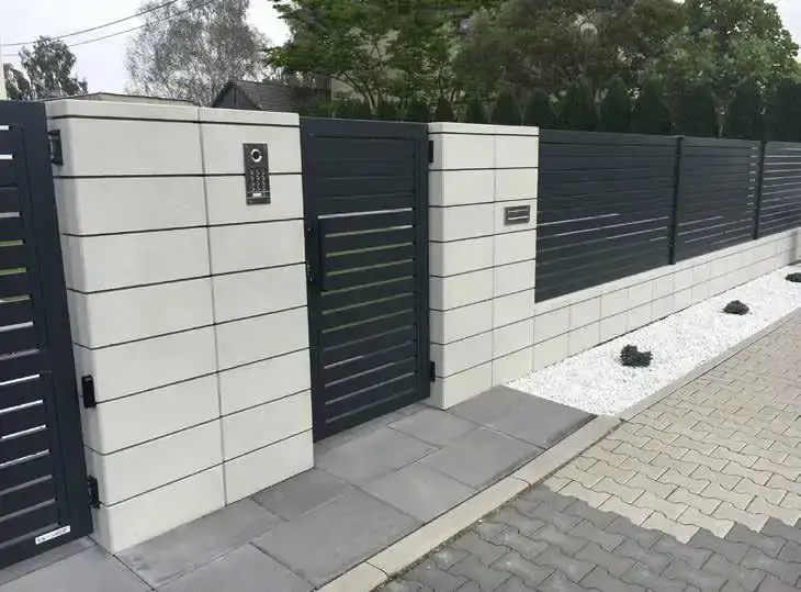 Narożnik ogrodzenia z białych bloczków i palisady